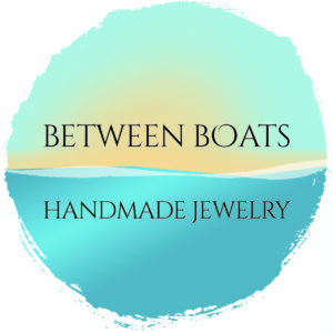 Lettering floating between sky and water, with a sun